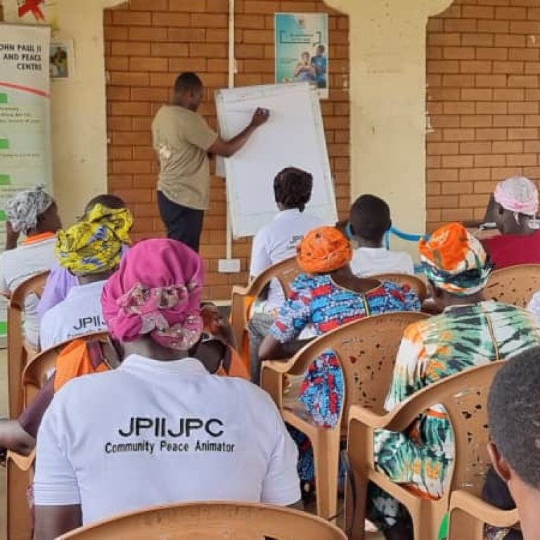 Facilitator training the women and RWCs during the peace bulding training in Bidibidi settlement
